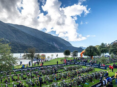 Aerial view of the meadow on the shore of Lake Molveno where the numerous mountain bikes of the X-Terra triathlon participants are deposited