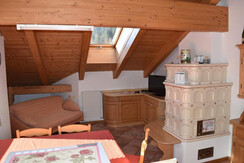 Cozy living room with stove and alpine decorations