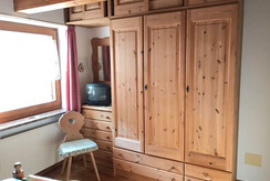 Bedroom with wooden wardrobe and window